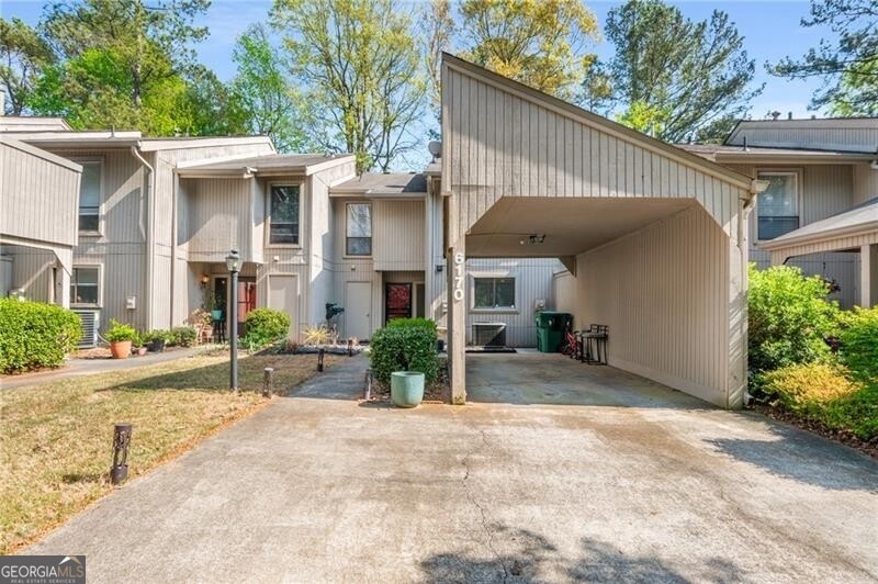 Front view of townhome with a carport and lots of 