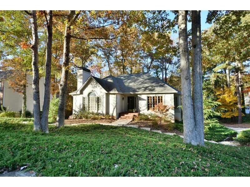 Exterior Front. Natural wooded lot with an elegant