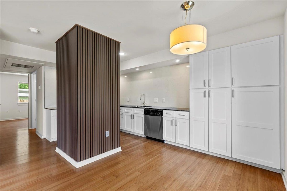 Kitchen with stainless steel dishwasher, a sink, 