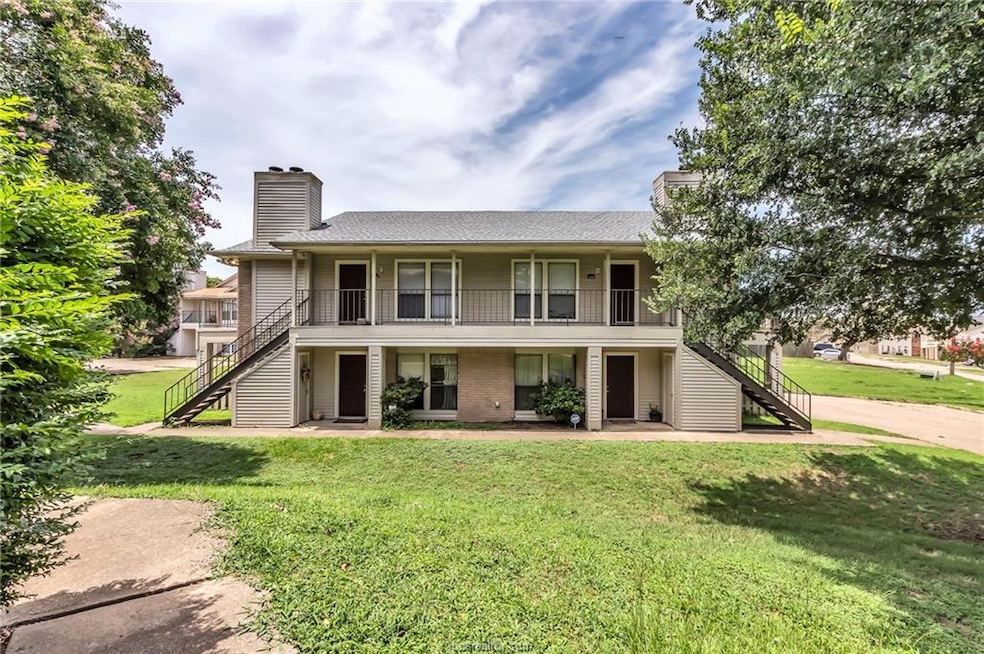 Front of property with stairs, a front yard, and a