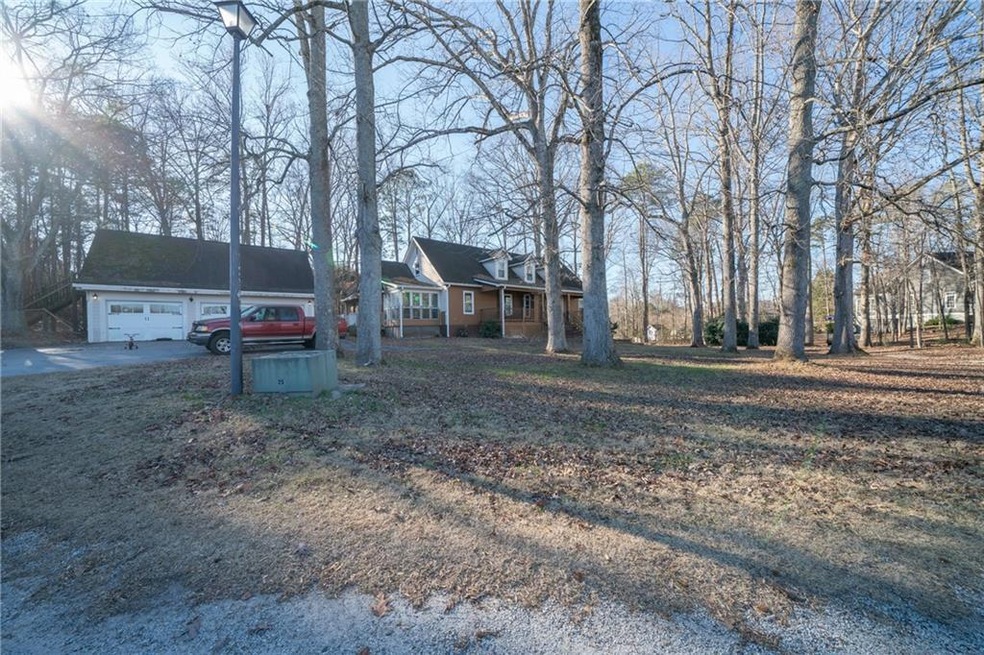 View of front facade with covered porch and a garage
