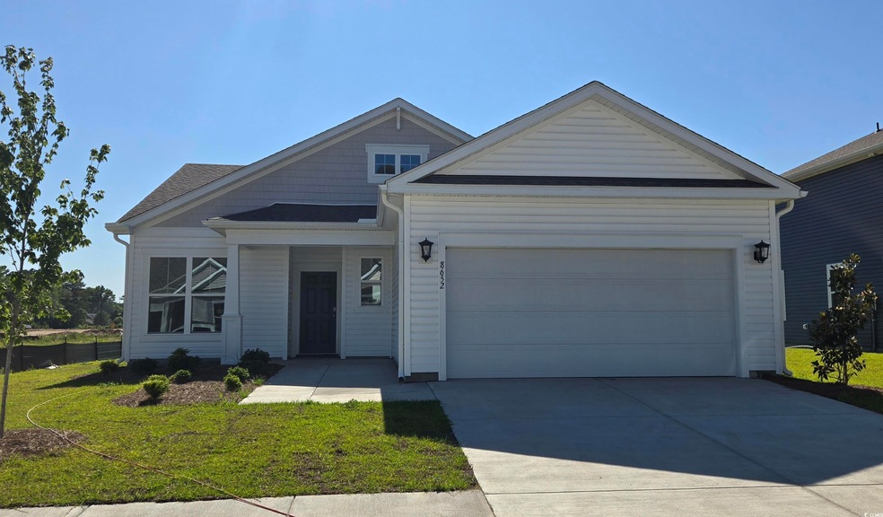 View of front of house featuring an attached garage and concrete driveway