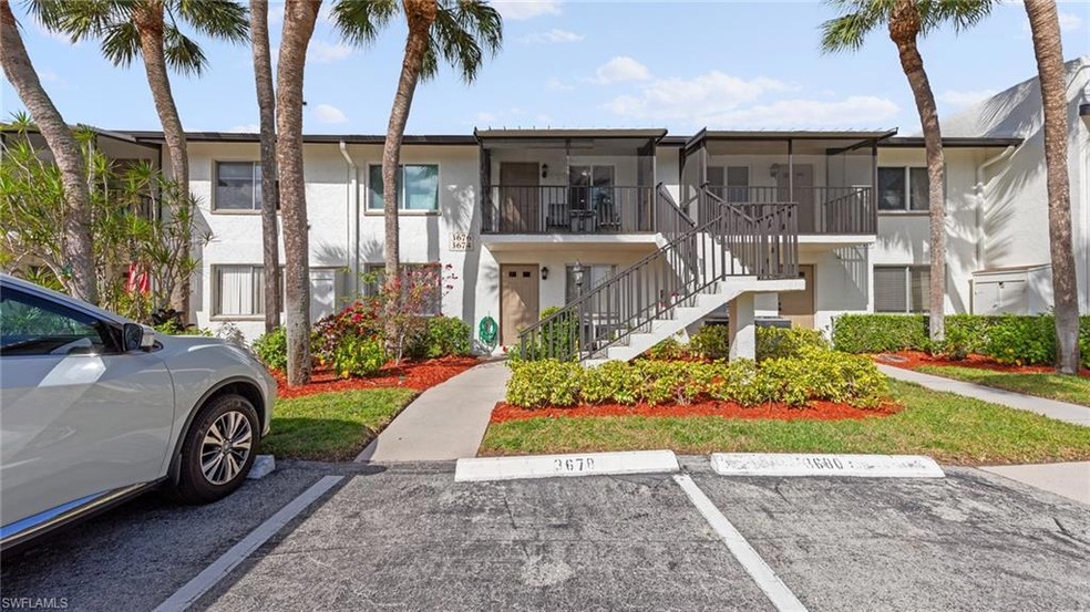 View of property featuring uncovered parking and s