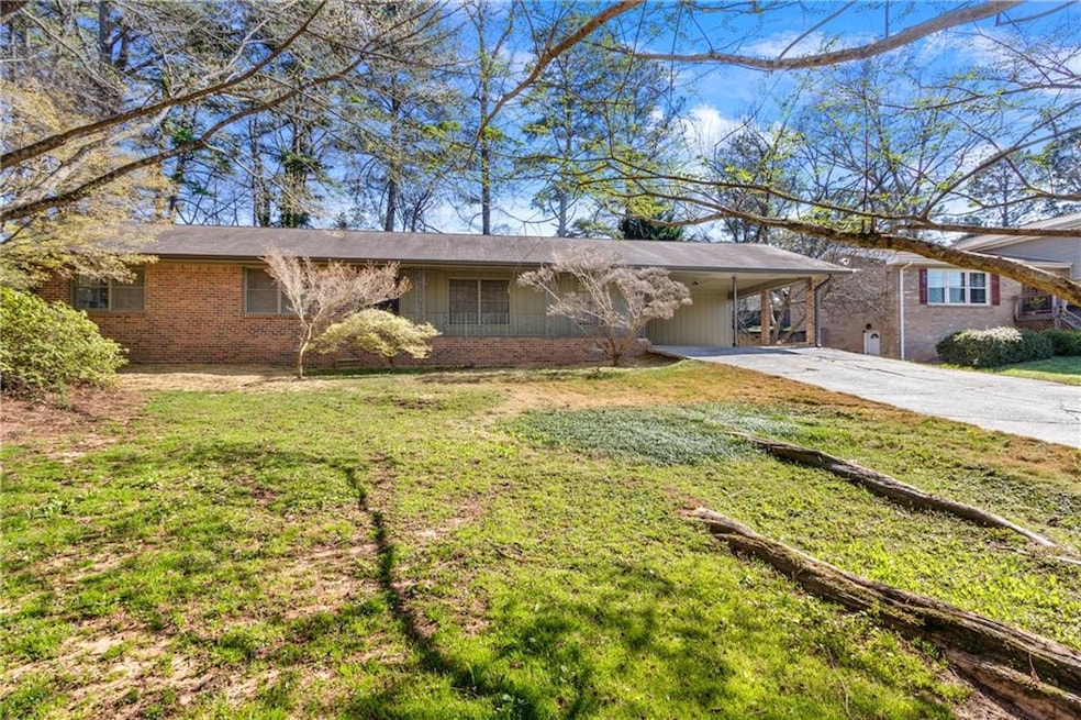 Single story home with a front yard, an attached c