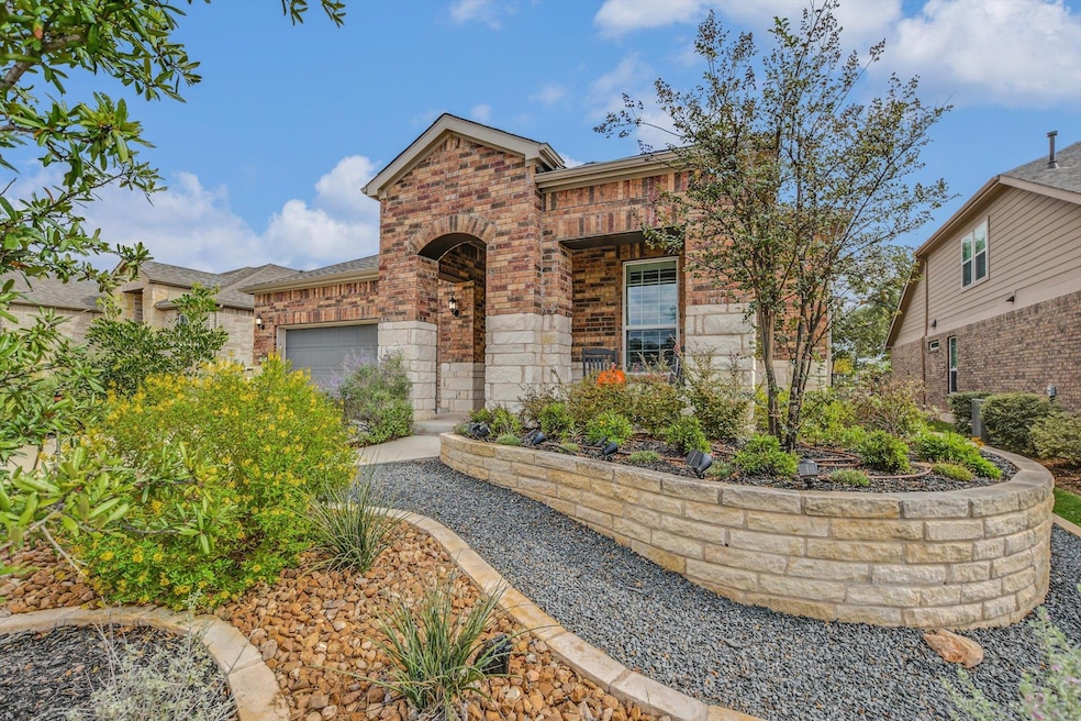 View of front facade with brick siding and an attached garage