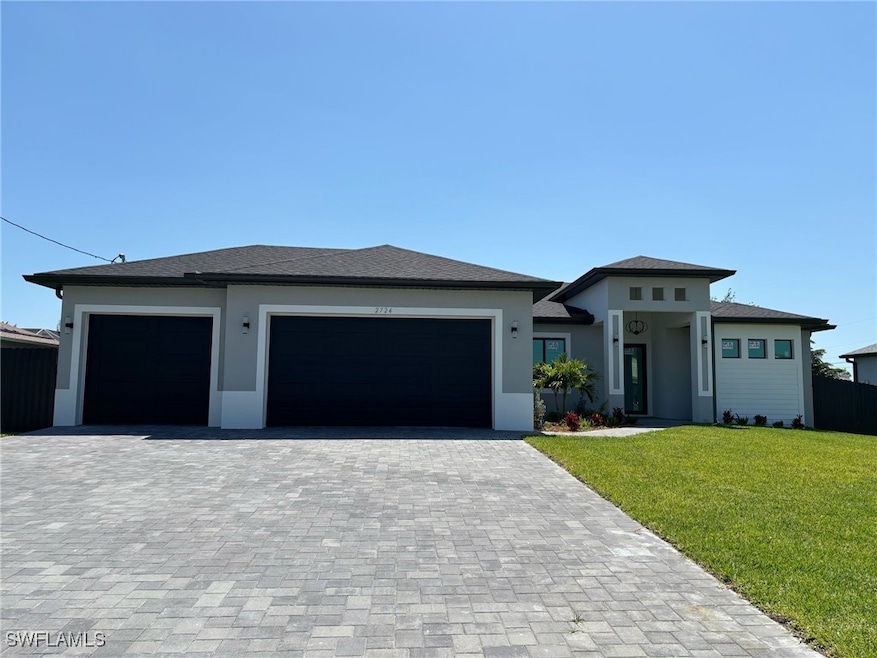 Prairie-style house with a garage, stucco siding,