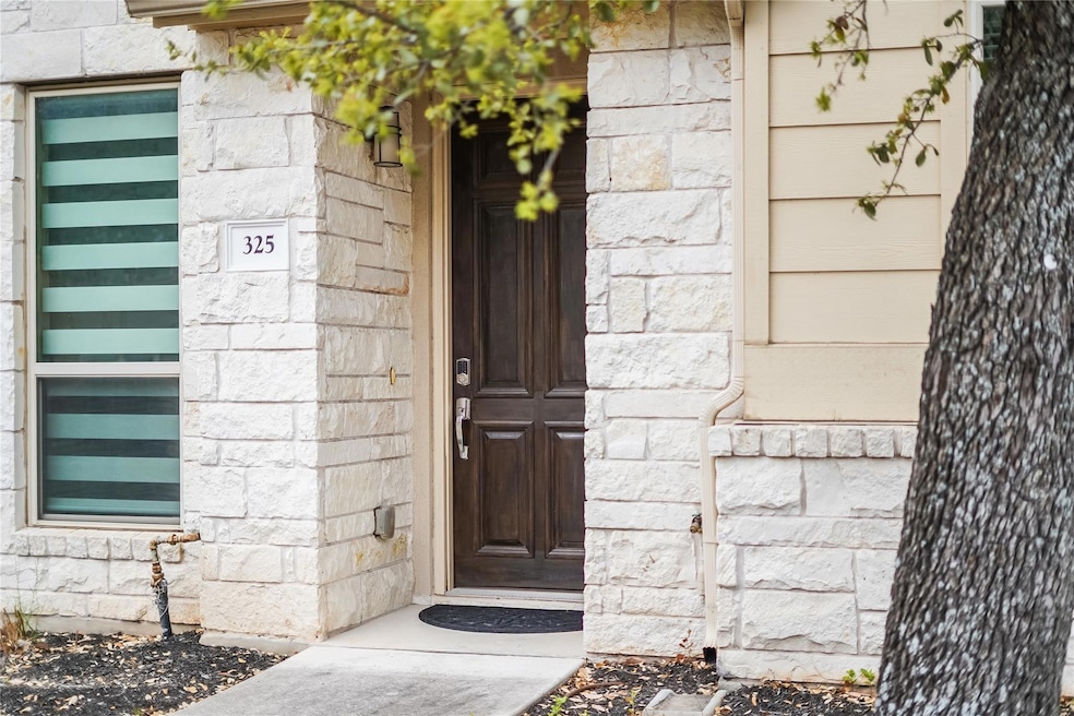 Entrance to property with stone siding