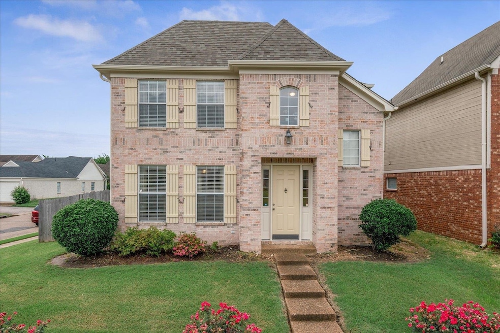 View of front of home with brick siding and a shingled roof