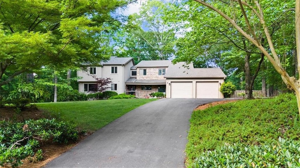 View of front of home featuring asphalt driveway, 