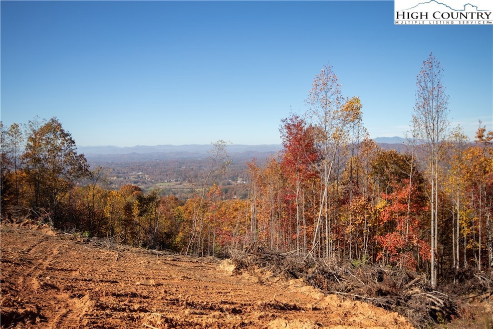 Clearing still in progress but view includes Mt Mitchell, Table Rock, Hawksbill, Grandmother and Grandfather (behind trees)
