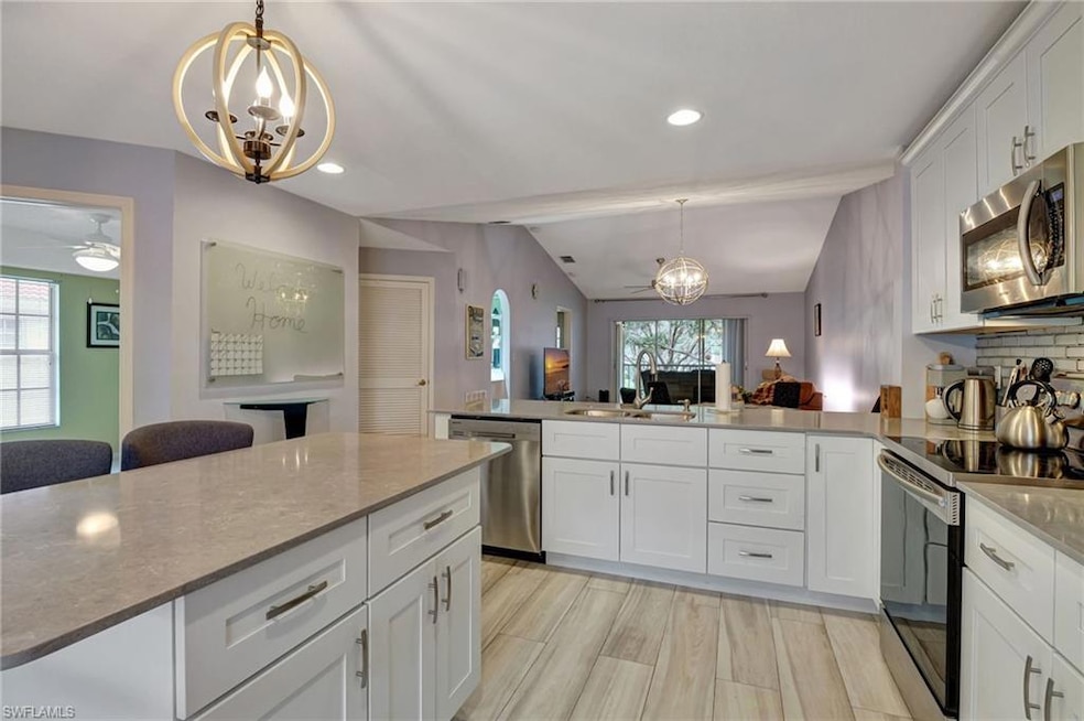 Kitchen featuring quartz counters and island, sink