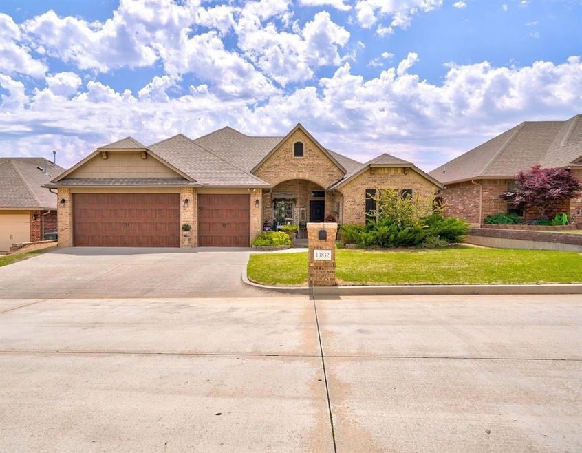 View of front of house with a garage and a front lawn