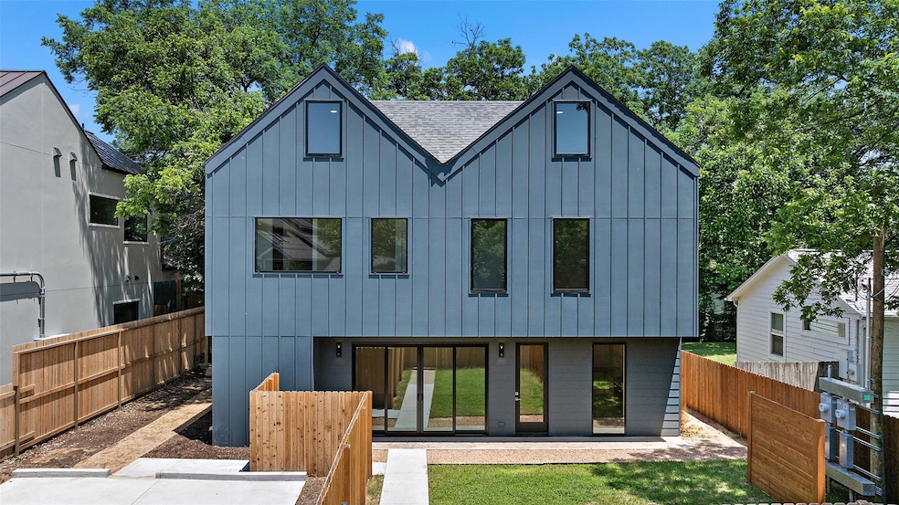 Rear view of house with board and batten siding, 