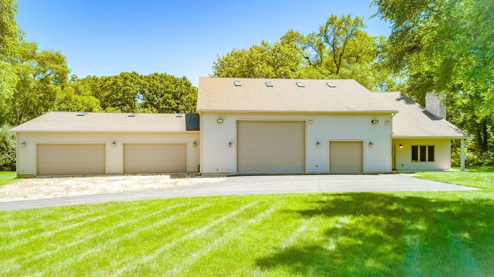 Nestled on 4.7 acres of fenced, rolling land