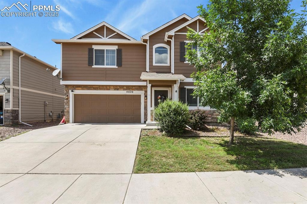 Craftsman-style home featuring stone siding, a garage, and concrete driveway