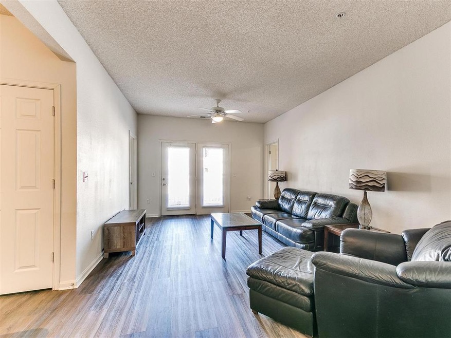 Living area featuring a textured ceiling, ceiling 