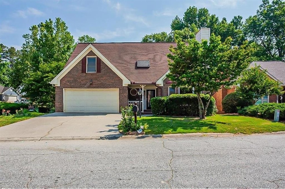 View of front of home with a front lawn and a gara