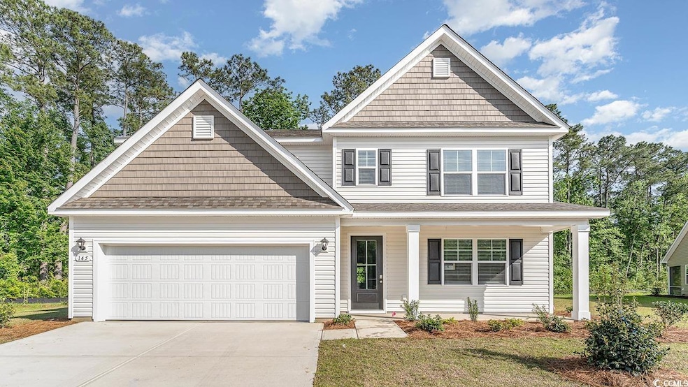 Craftsman-style house featuring a shingled roof, driveway, a porch, an attached garage, and a front lawn