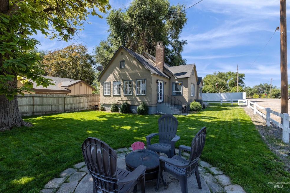 Back of property with a chimney, a fenced backyard, and a patio area