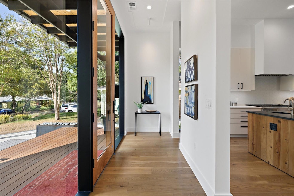Corridor with recessed lighting, baseboards, visi