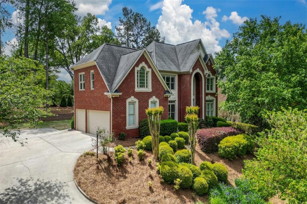 Beautiful view of the home with side three car gar