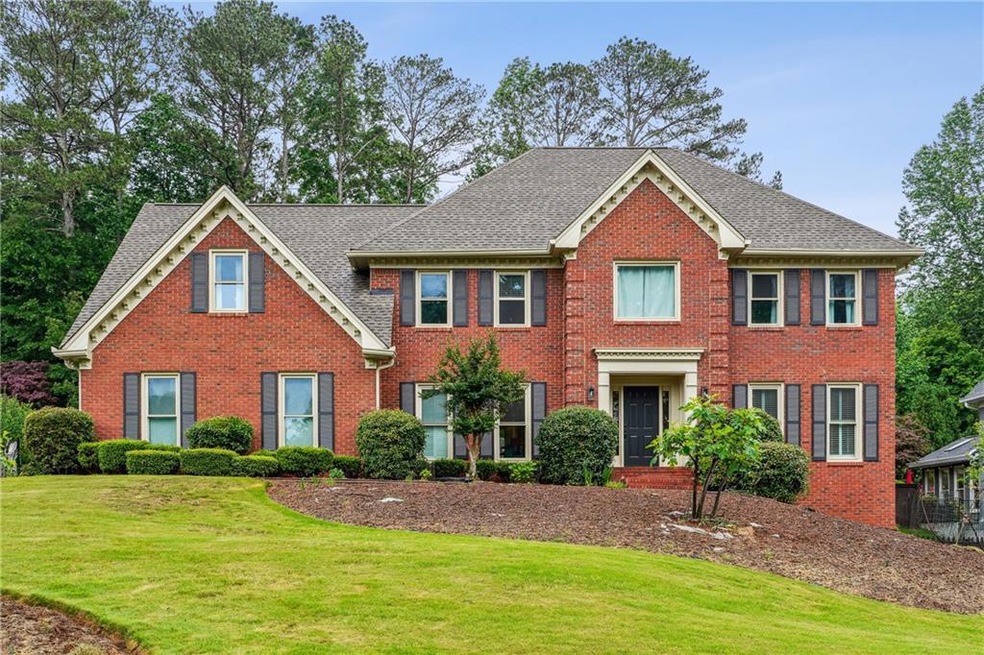 Colonial-style house with brick siding, a front la