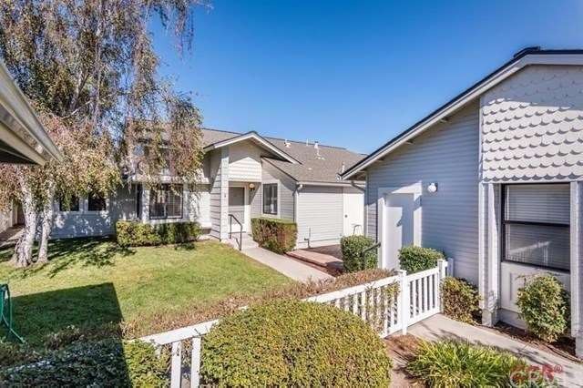 Front view of home with walkway to front door, bri
