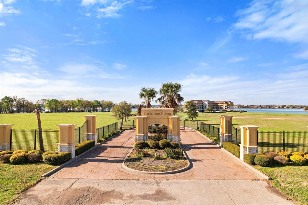 View of home's community featuring a gate, a water