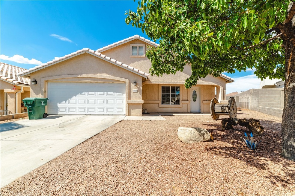 View of front of property featuring a garage, driv