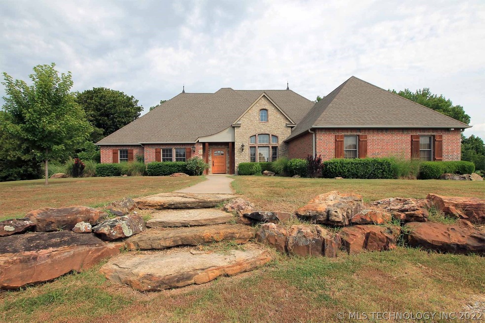 Lovely rock path leading to covered front entry.