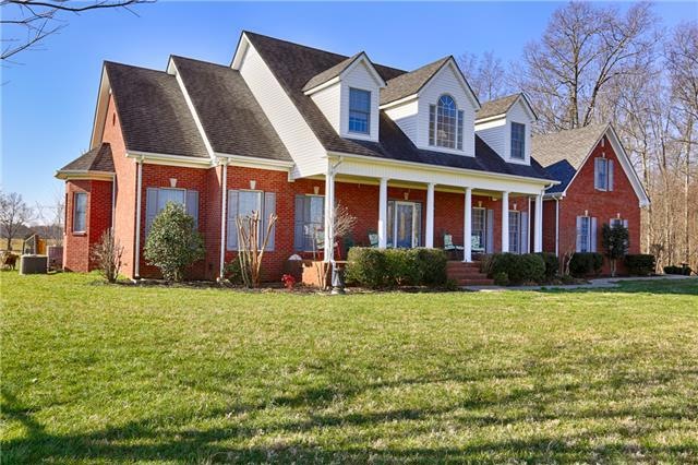 Front of Home     This full brick home is situated on over 26 acres of farm land.
