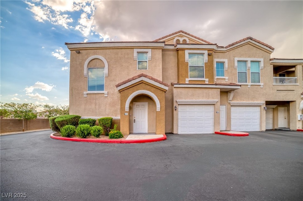 View of property featuring stucco siding, driveway