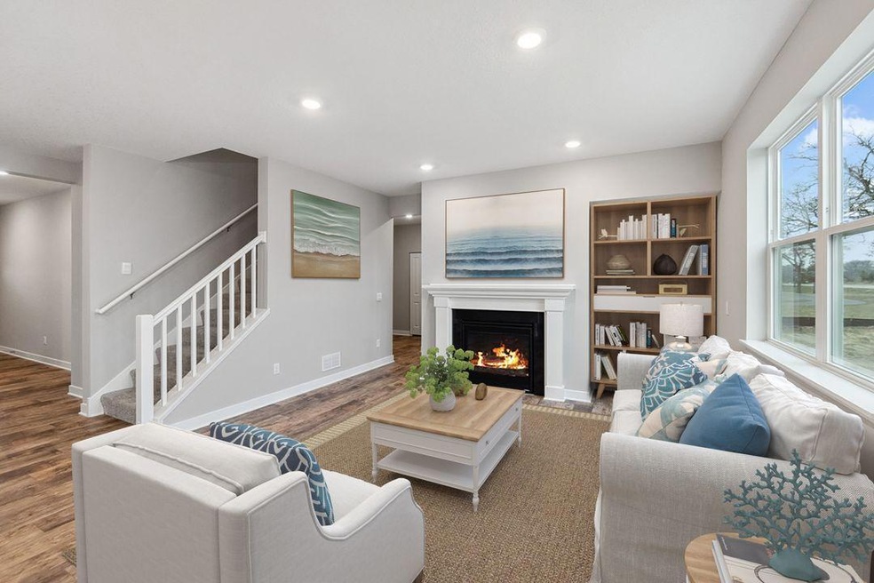 Enjoy a gas fireplace with stone surround and painted mantle. Photo is virtually staged, built-in shelves not included.