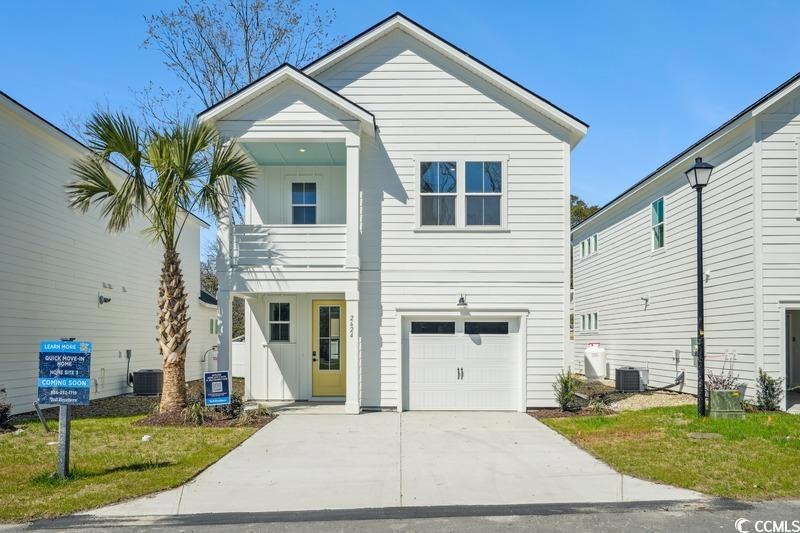 View of front of property featuring concrete drive