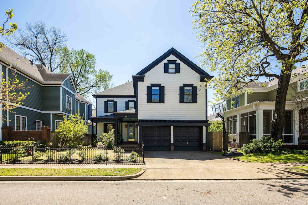 View of front of property featuring a garage and concrete driveway