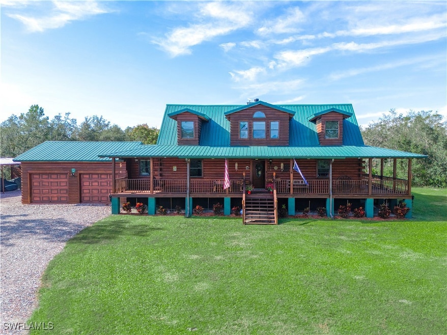 Log-style house with a garage, covered porch, and