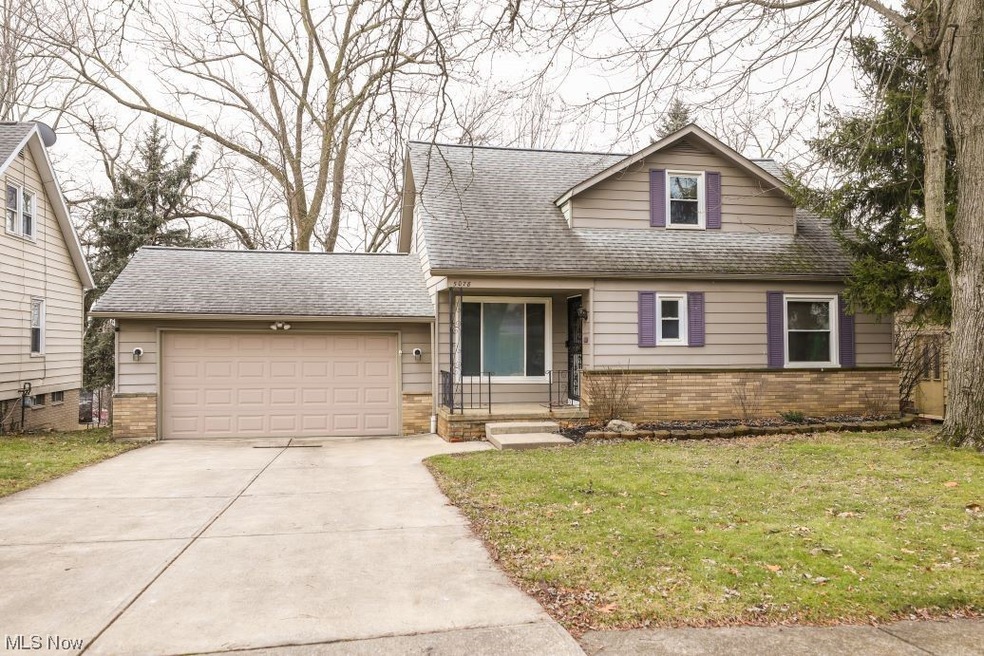 View of front of house featuring a front yard and a garage