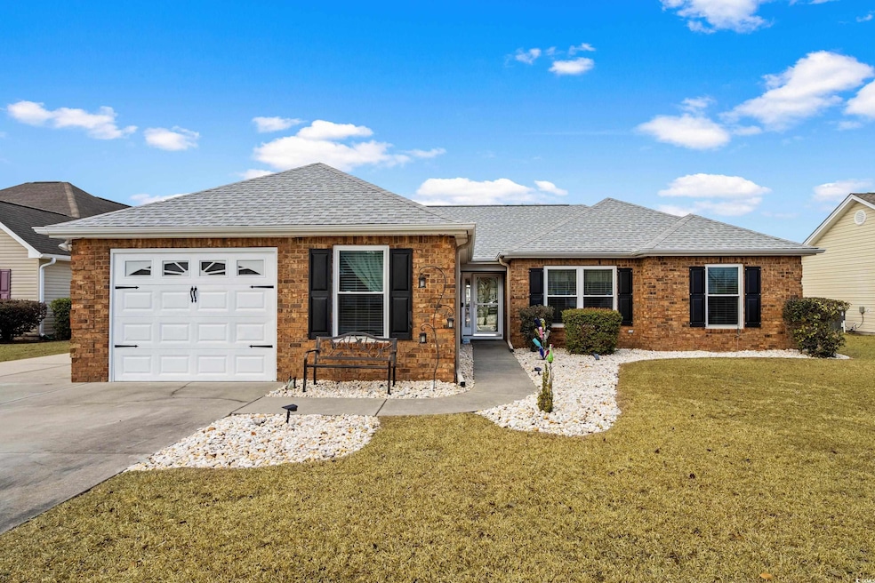 Single story home with a garage and a front yard