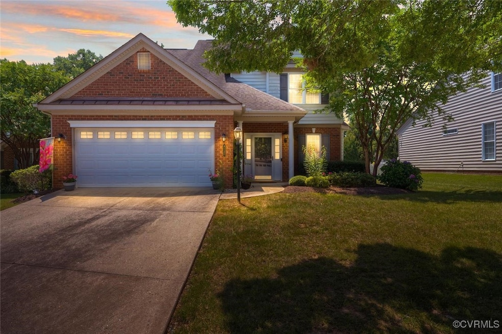 View of front facade with a garage, brick siding,