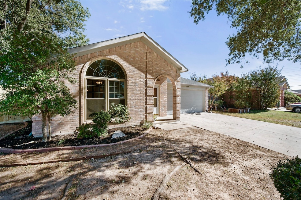 View of side of property with brick siding, concrete driveway, and a garage