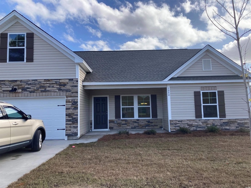 View of front facade featuring a garage, a front l