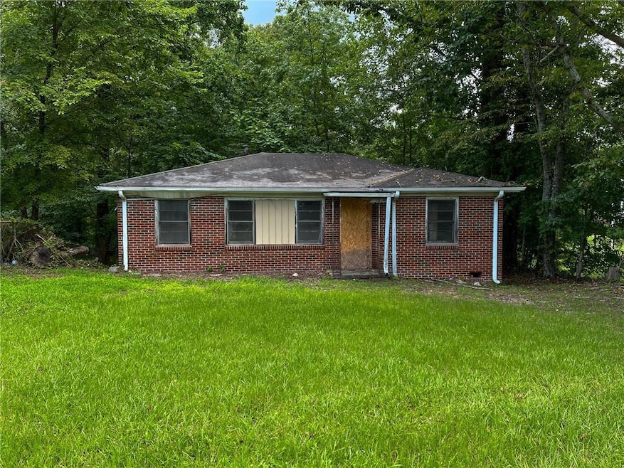 Single story home featuring a front lawn