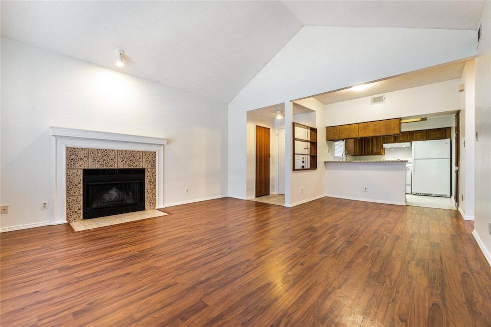 Unfurnished living room with dark wood-type floori