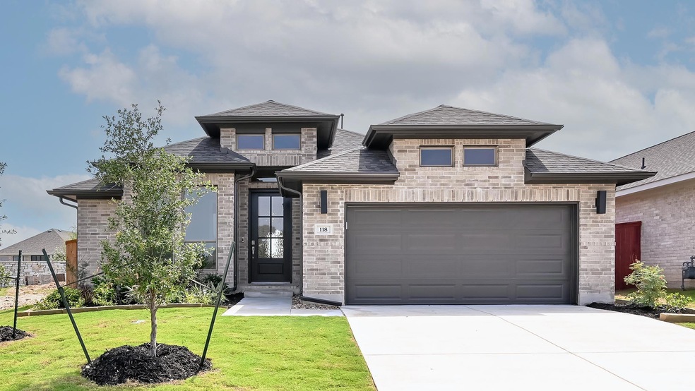 View of front of home with driveway, a garage, a 