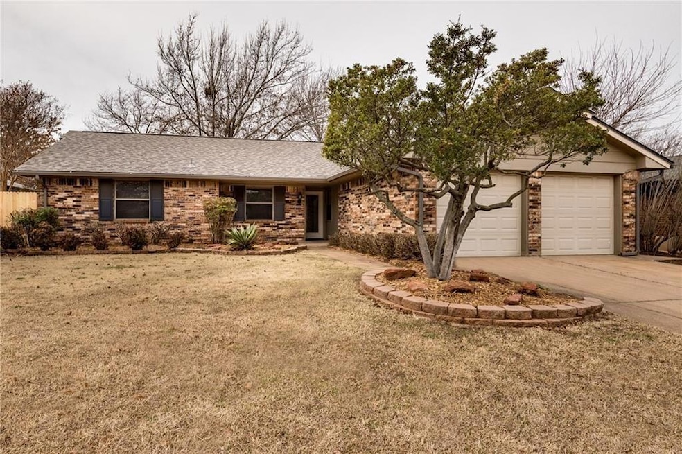 Ranch-style house with concrete driveway, a front 