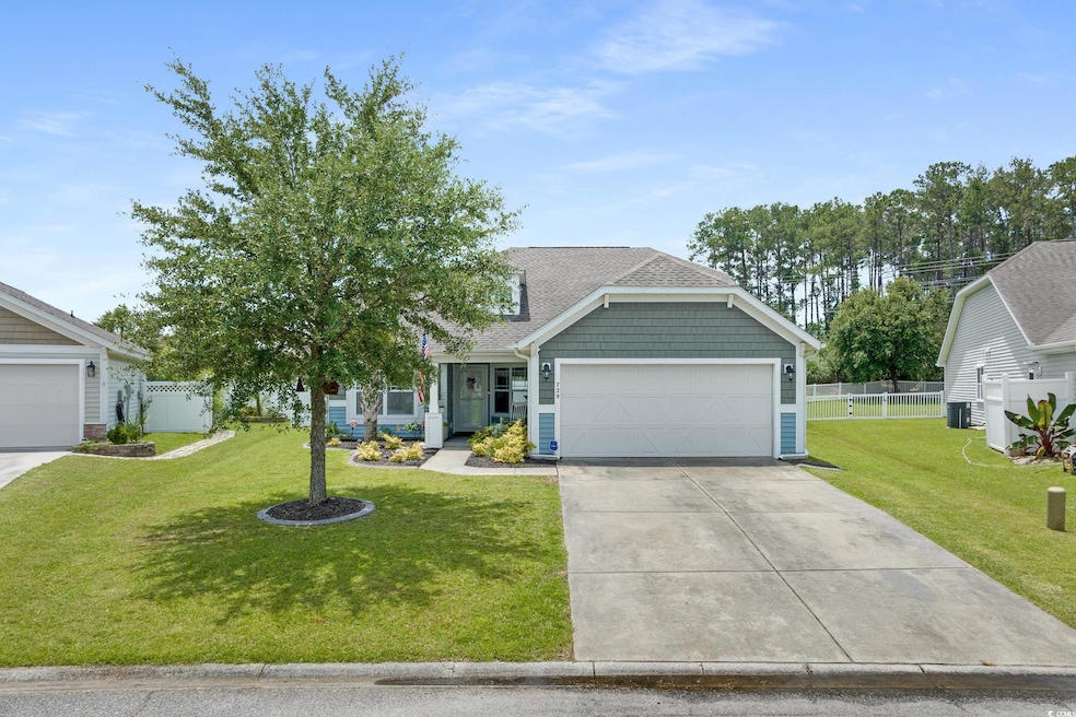 View of front facade with driveway, a garage, and a shingled roof