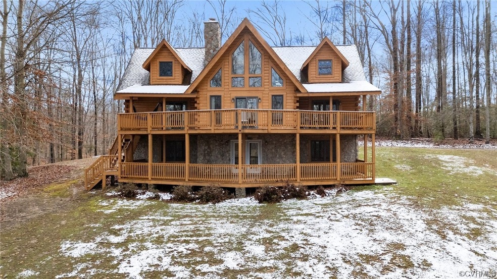 Snow covered property with a yard