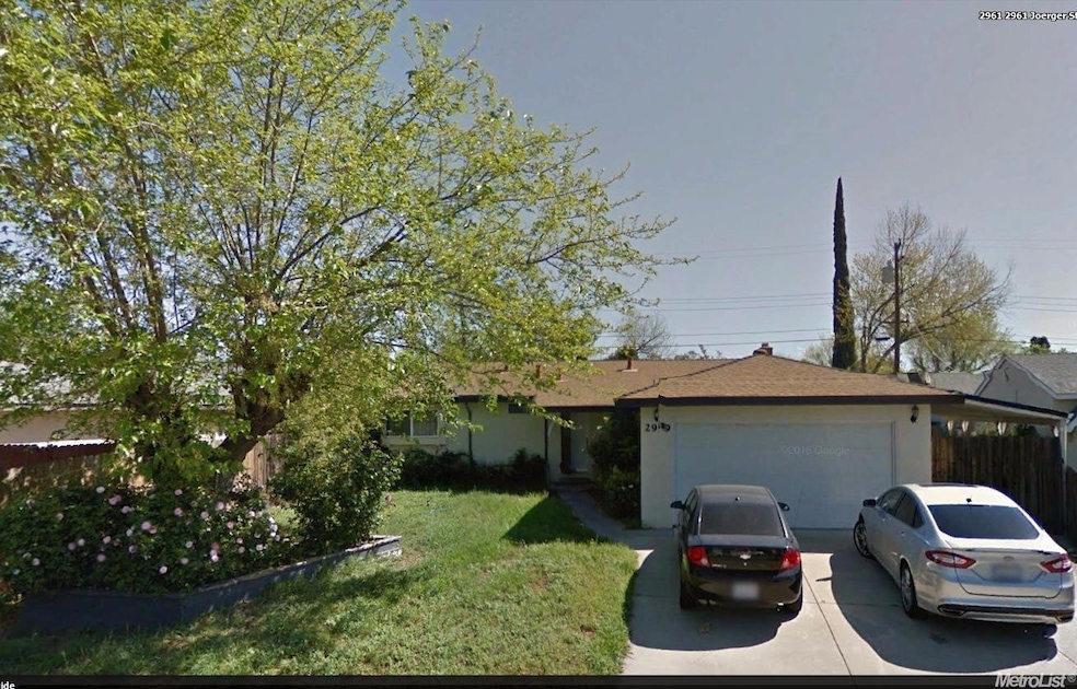 Single story home features cover RV parking.