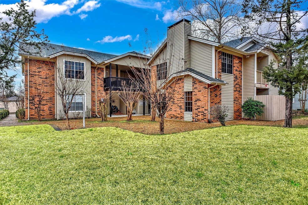 View of front facade with a balcony and a front yard
