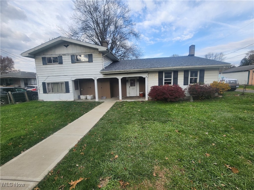 View of front facade featuring a chimney and a porch